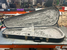 Charger l'image dans la galerie, Open hardshell tear drop electric guitar case with plush interior lining and metal latches on a workbench