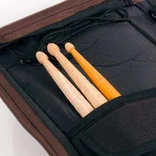 Load image into Gallery viewer, SABIAN Arena stick bag in black with brown accents holding drumsticks
